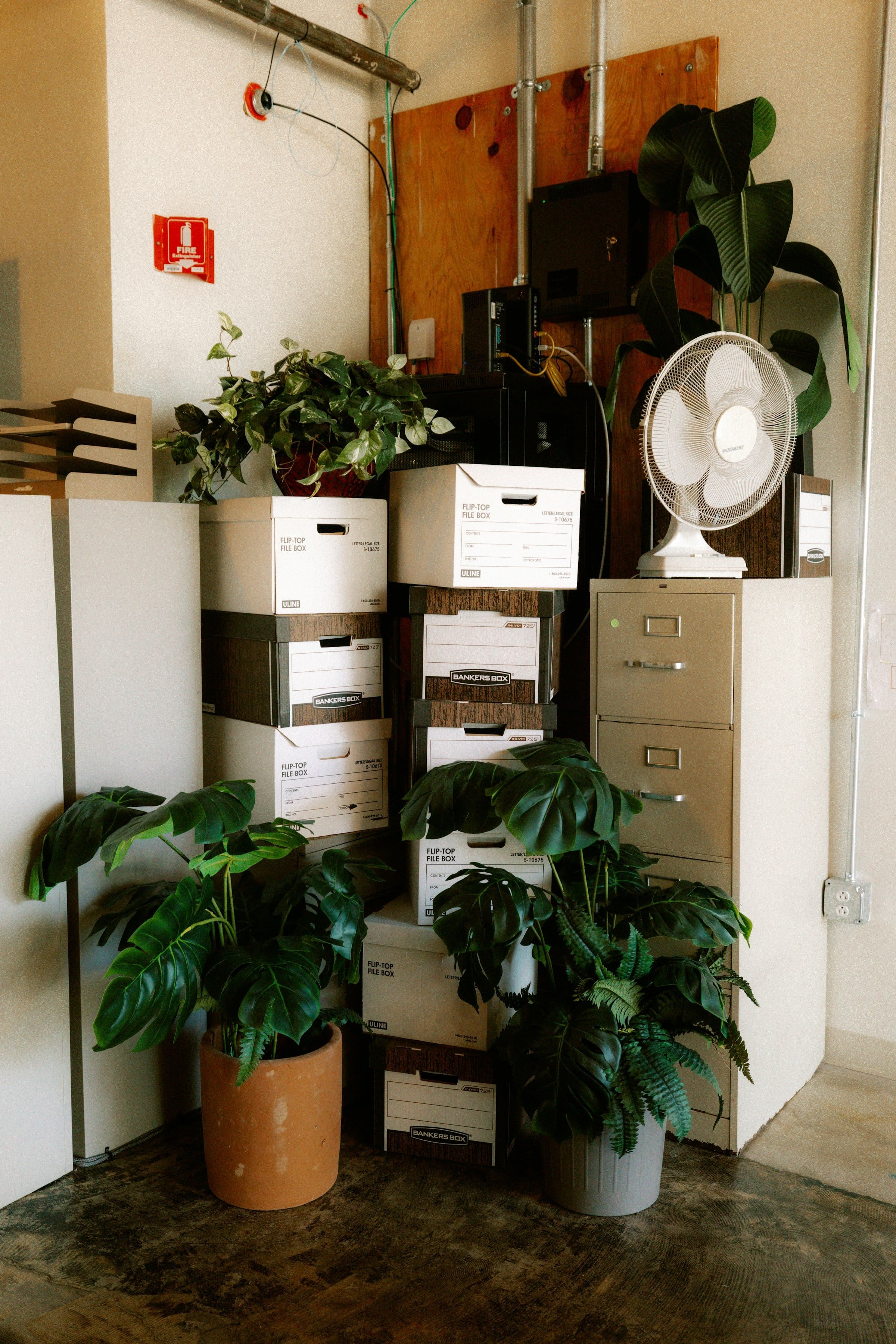 Office corner with file boxes and a filing cabinet ready to move