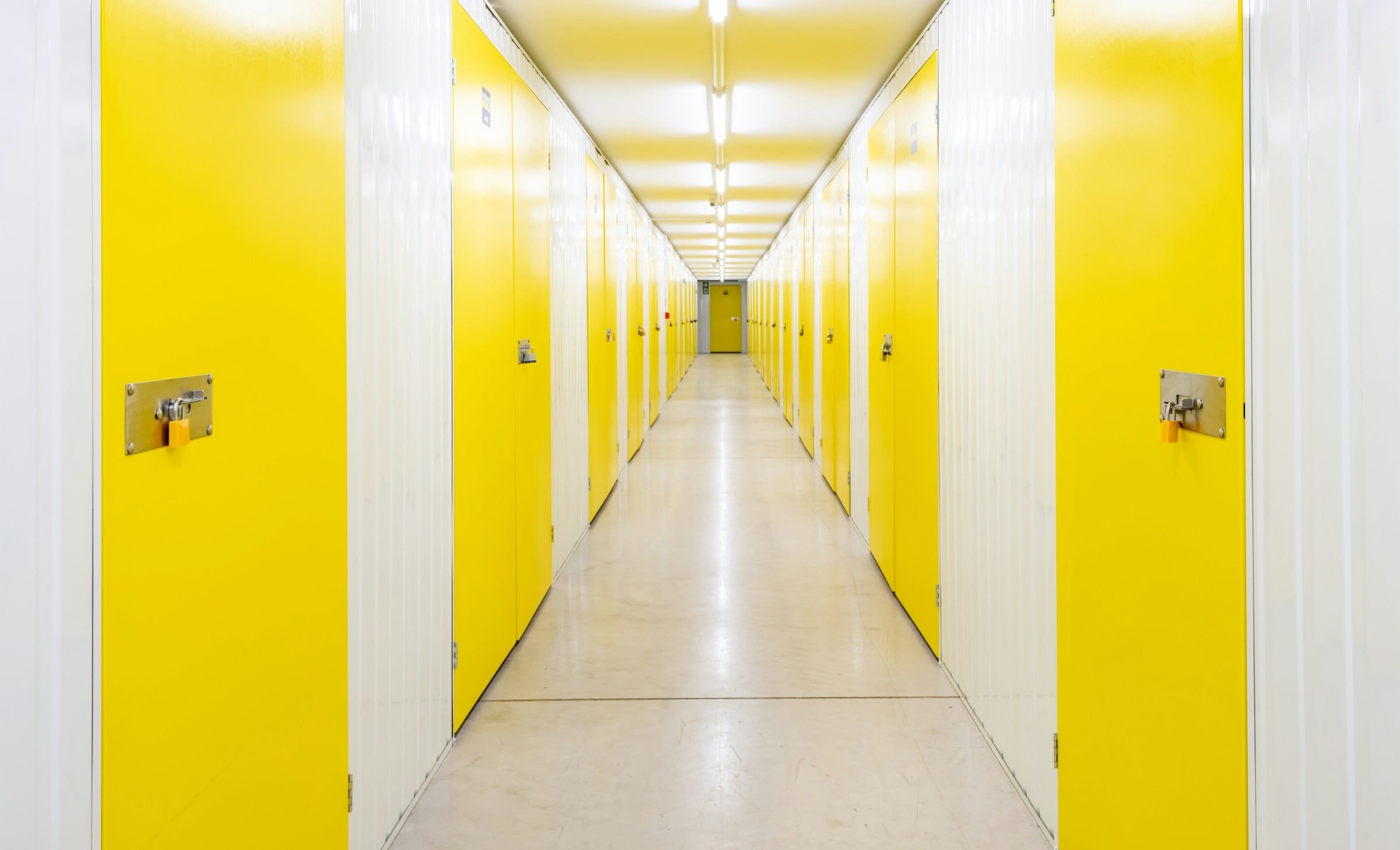 Clean self-storage corridor with rows of unit doors